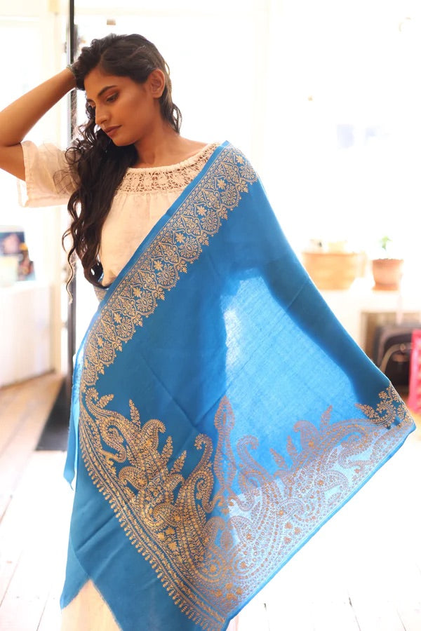 image of woman wearing hand made  light blue shawl