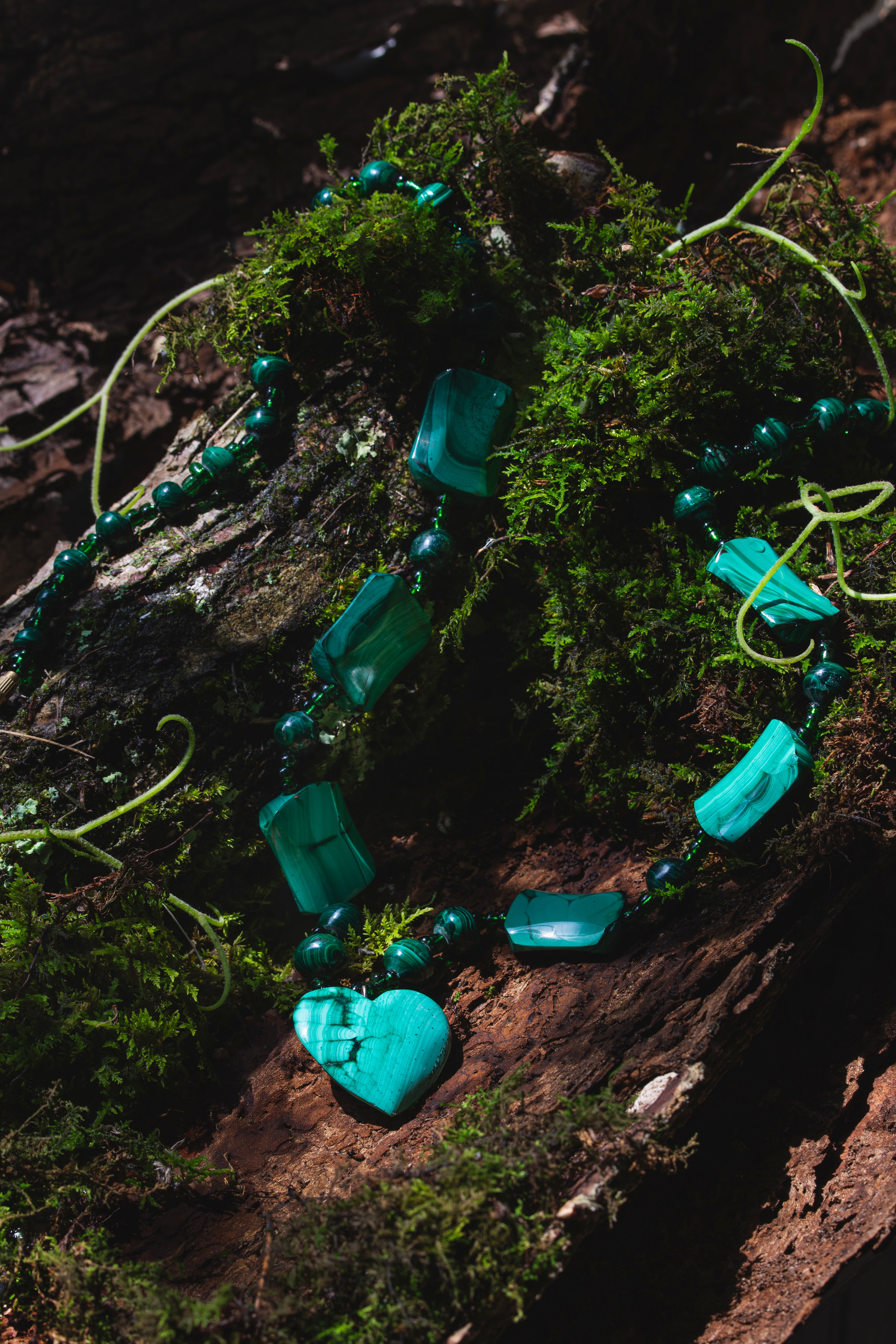 image of a turquoise necklace with heart-shaped, cylinders, and rectangle stones